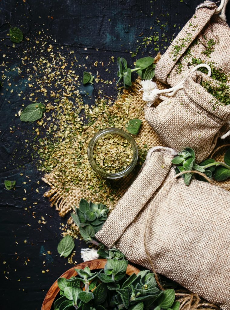 Dried ground oregano or marjoram, dark background, top view